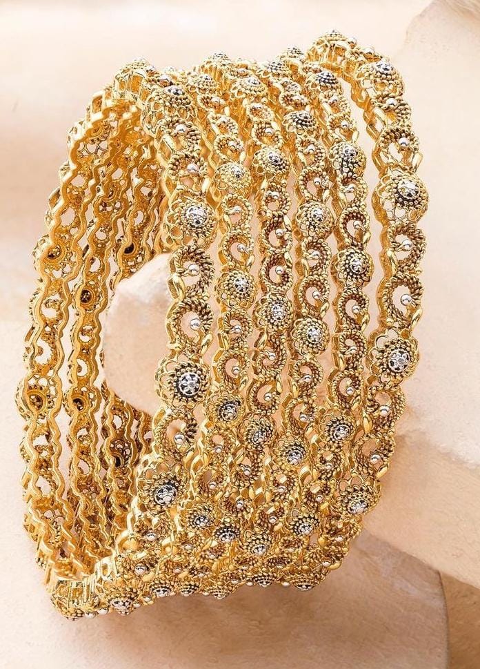 Filigree gold bangle with intricate pattern