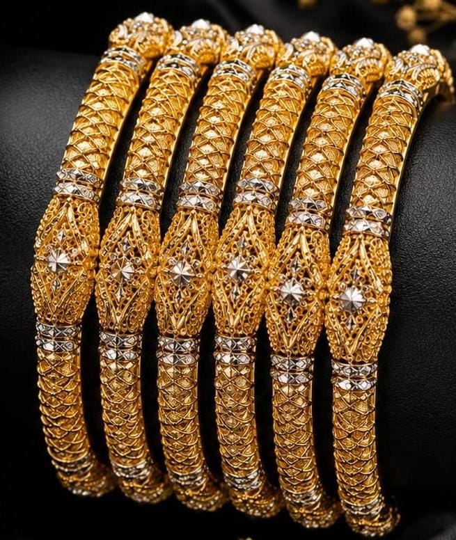 Set of six detailed gold bangles with white gold accents and filigree design