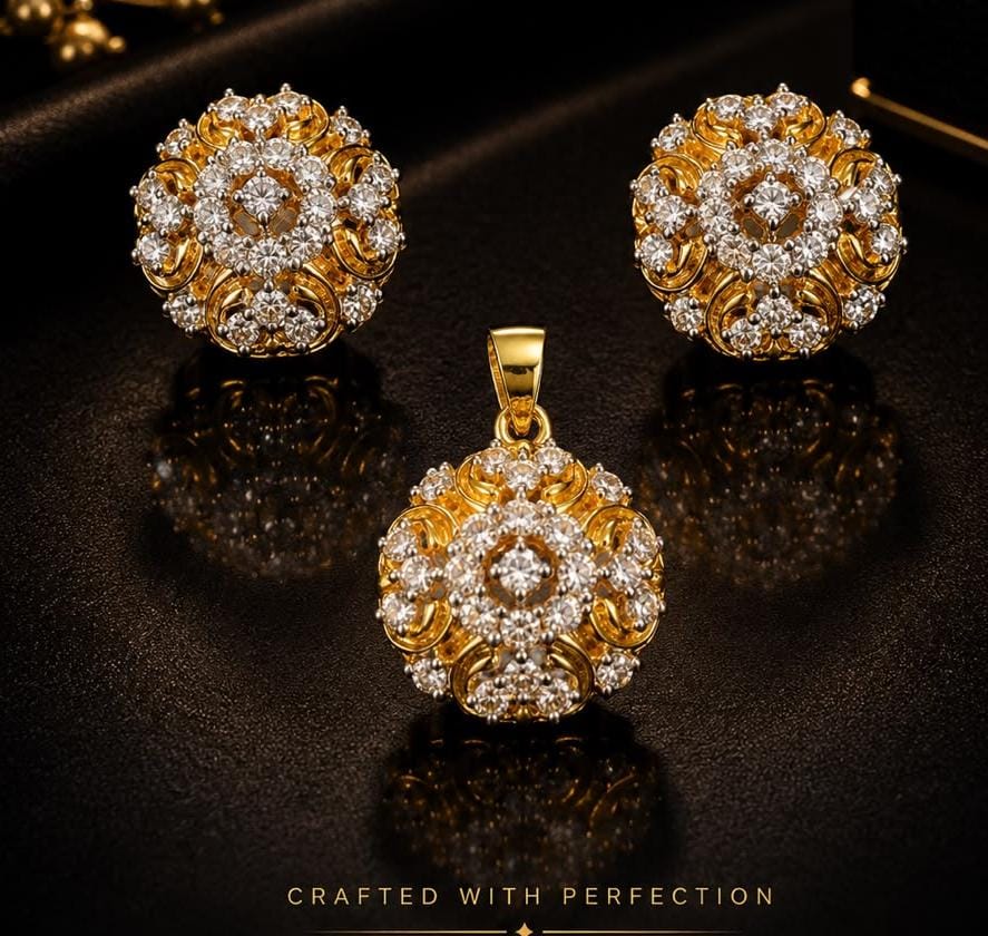 Intricately designed gold earrings and matching pendant with diamond accents