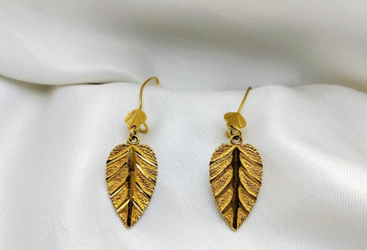 Leaf-shaped gold drop earrings with a textured surface