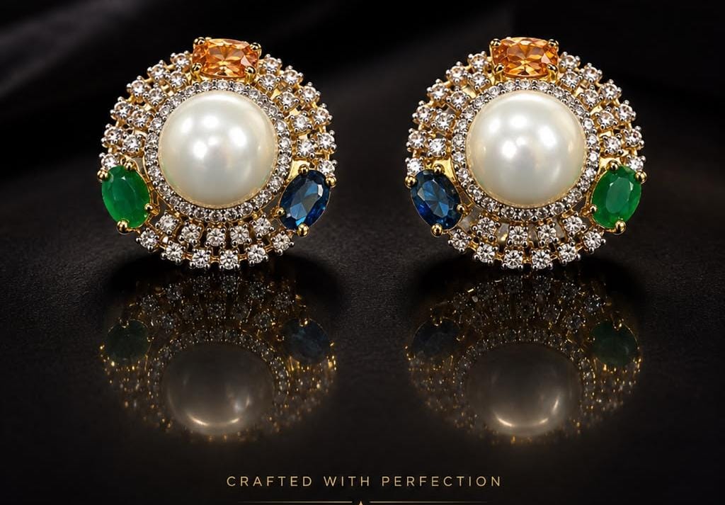 Pearl stud earrings surrounded by diamonds, emeralds, and sapphires