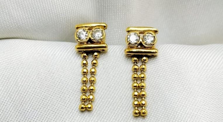Linear gold earrings with two diamonds and dangling bead chains
