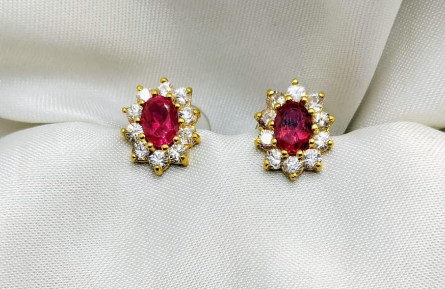 Oval ruby studs surrounded by a diamond halo